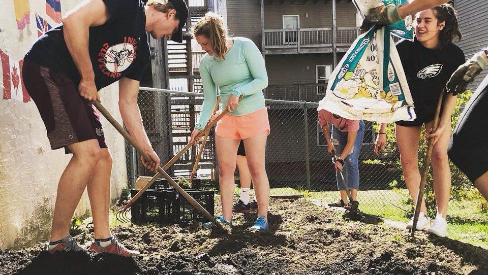 Bates’s Swim and Dive team help the center build a garden. 
ERIN REED/COURTESY PHOTO