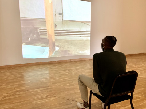 Osceola Heard ‘22 watches “The Way Things Go” by Swiss artist duo Peter Fischli and David Weiss in the Bates Museum of Art