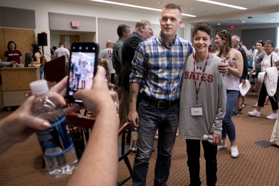 Jared Golden ‘11 and fellow U.S. Representative Ben Cline ‘94 spoke at Reunion in 2019. Here, Golden is taking a photo with the son of a Bates alum in Pettengill Hall. 