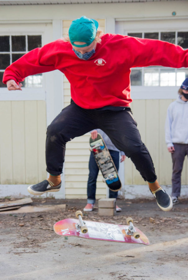 Tommy Shiels 21 performs a trick with his skate board in front of the Shred Barn. The Shred Barn has been the gathering place for the club for almost a decade. 