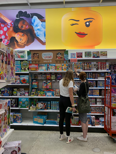 Shoppers Grace Thomas ‘26 and Hope Stafford ‘26 discuss which puzzle to purchase after failing to find Spider-man walkie talkies in the new Auburn Target.