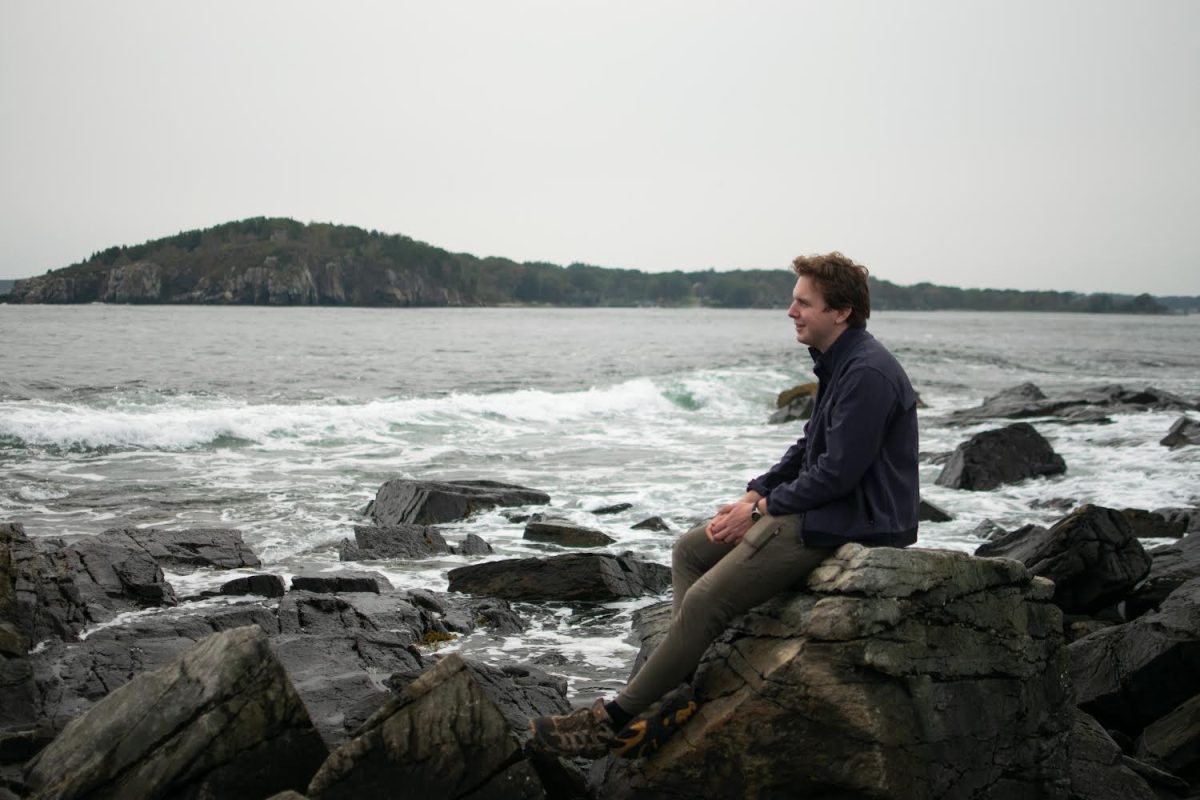 Sam Skinner 25, a trip leader for the Bates Outing Club (BOC) and the student behind the clubs Introductory Hiking series, gazes into the ocean on a BOC trip. Colby Green/The Bates Student