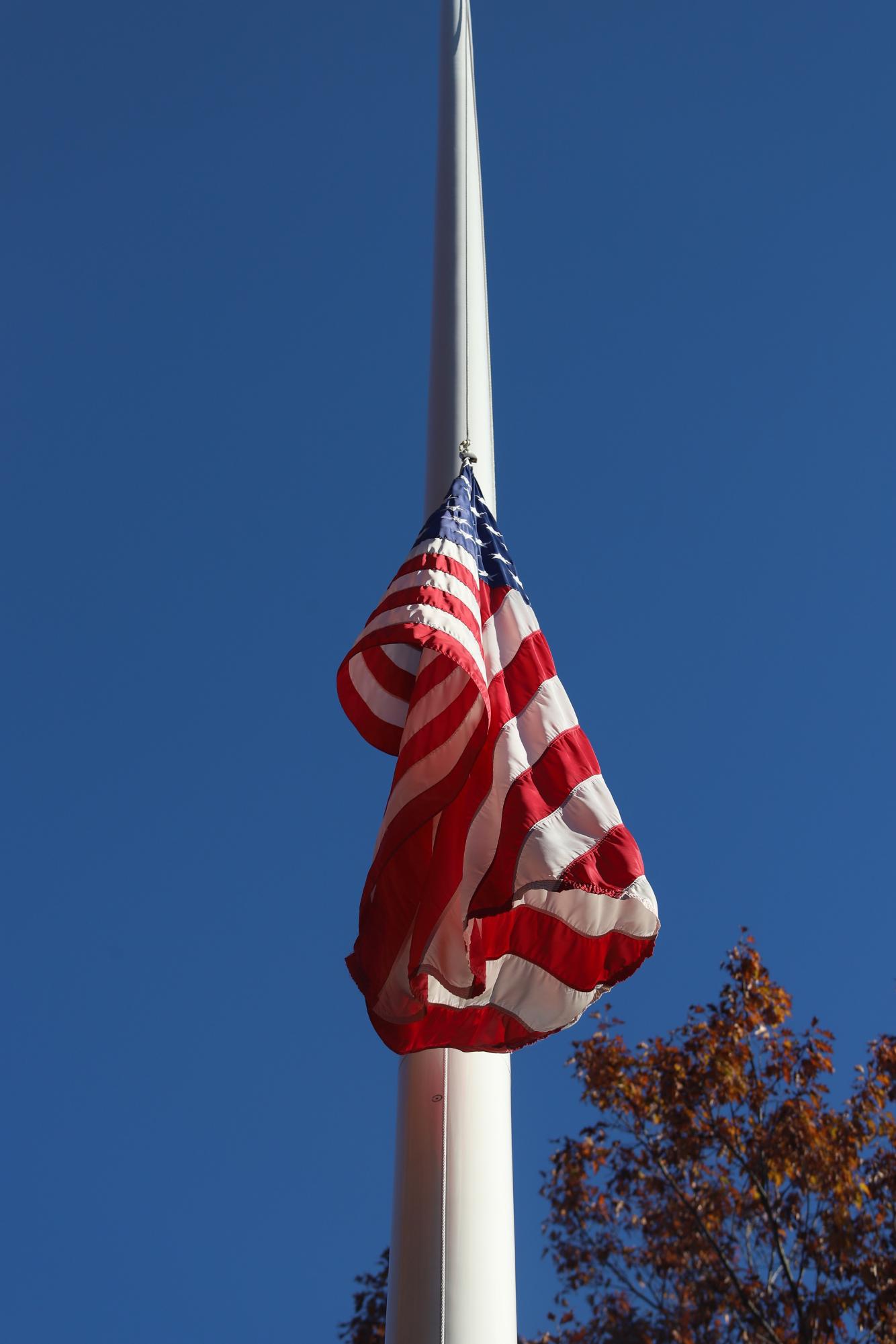 The flag on the Bates quad hangs at half staff after the mass shooting on Oct. 25. Carly Philpott/The Bates Student