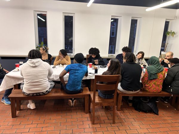 Students sitting around the table in the Office of Intercultural Education. 