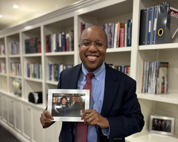 President Garry Jenkins holding a picture of him and Supreme Court Justice Sonia Sotomayor.