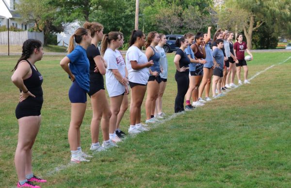 Women's Rugby Team listening to directions to do a defensive drill on Thursday, Sept. 19 on Page Field.