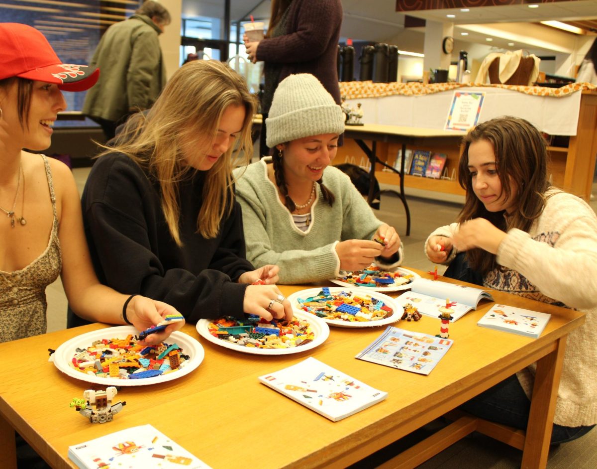 From left to right: Naomi Lynch '25, Grace Flaherty '25, Mattea Baumgardener '26, and Annie Robinson '26 build their own Lego creations at the Lego Showcase at Ladd Library on Monday, October 28th.