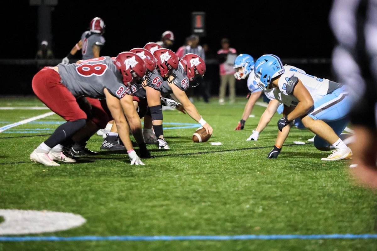 Bates Varsity Football lines up against Tufts.