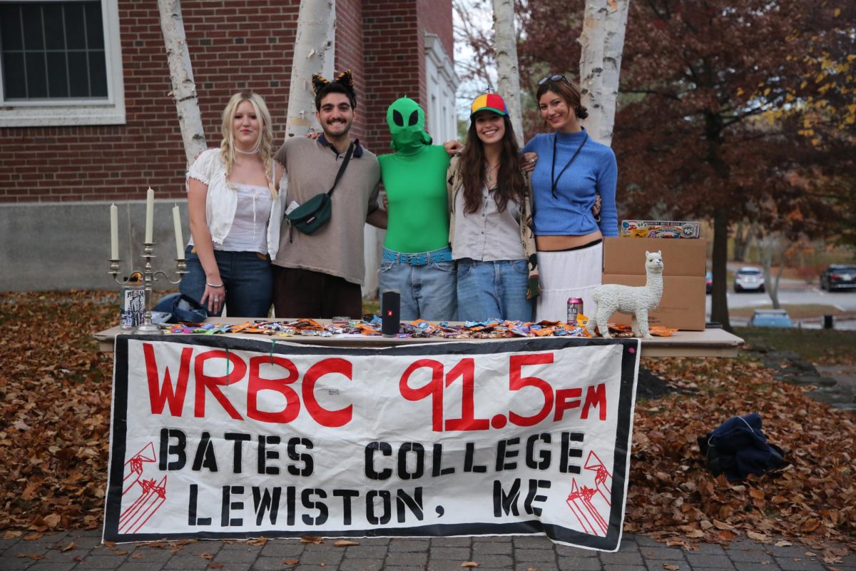 (From Right to Left) Keera Levell ‘28, Lauren Georgeou ‘25, Robo DJ '2?, Matt Riseman ‘26, and Olivia Torrington 27 pose behind their WRBC booth.
