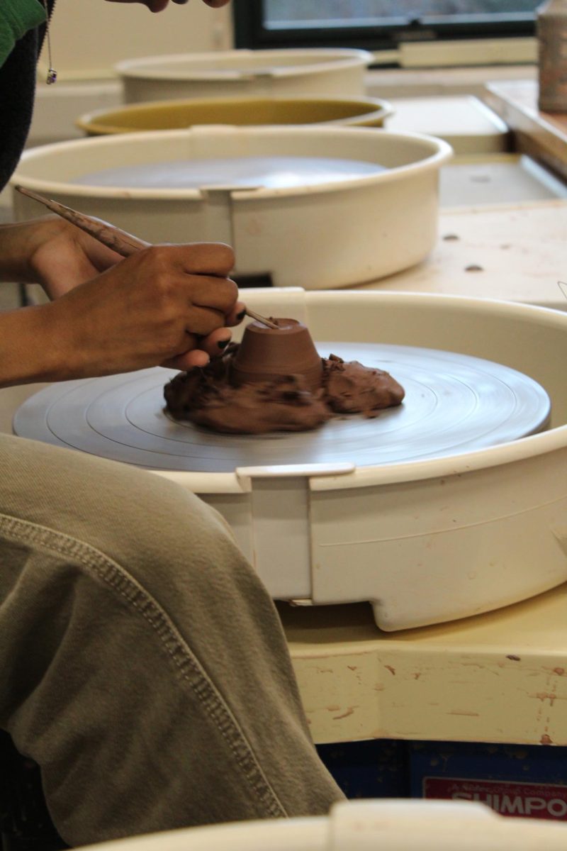 Tadalech Clowney, Class of '28, trims her ceramics project on the wheel. 