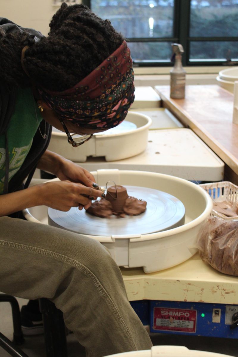 In the ceramics studio as Tadalech Clowney, Class of '28, trims her project on the wheel. 