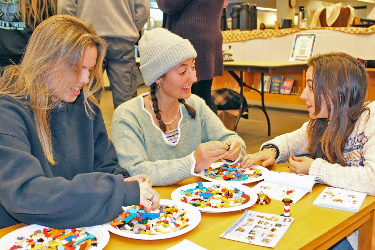 From left to right: Grace Flaherty '25, Annie Robinson '26 and Mattea Baumgardner '25 build lego sets at the Lego Showcase Event at Ladd Library on Monday, Oct. 28.