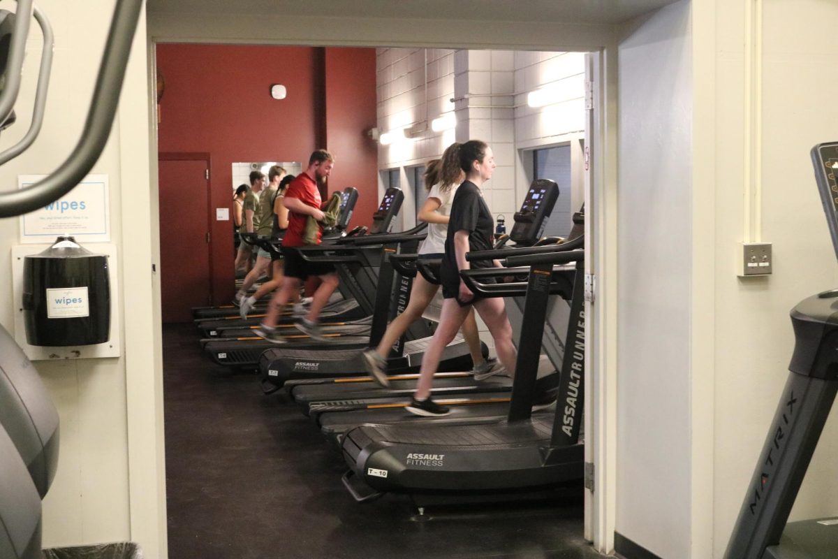 Students running on treadmills in Merrill Gymnasium.