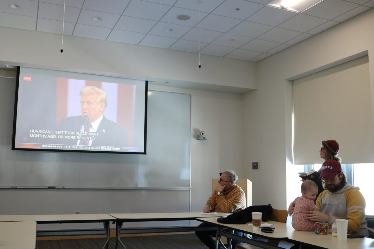 Professors Stephen Engel and Stephanie Kelley-Romano watching President Donald Trump deliver the 47th inaugural speech.