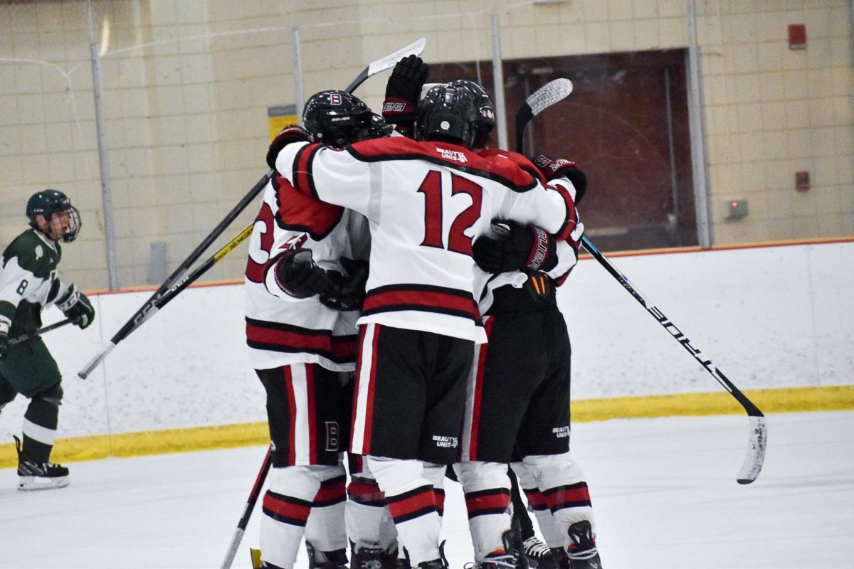 The Bates Men's hockey team celebrating after scoring a goal to even up the score of the game.