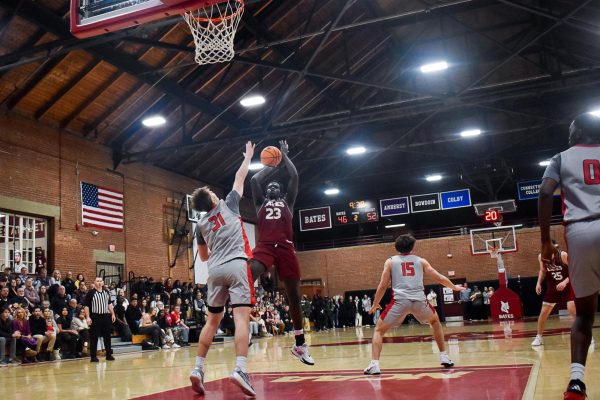 Babacar Pouye '27 taking a shot during the Bates vs. Wesleyan basketball game.