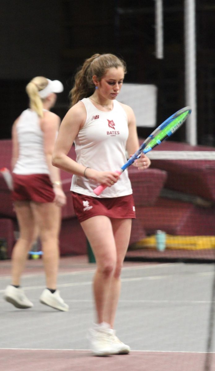 Olivia Gidlow, Class of '25, preparing to serve during the Bates' Women's Tennis match on Friday, March 7th. 