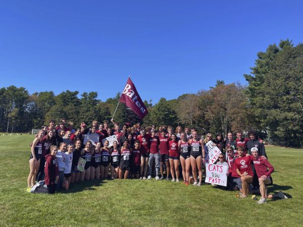 The Bates XC team takes a group photo along with fellow supporters.