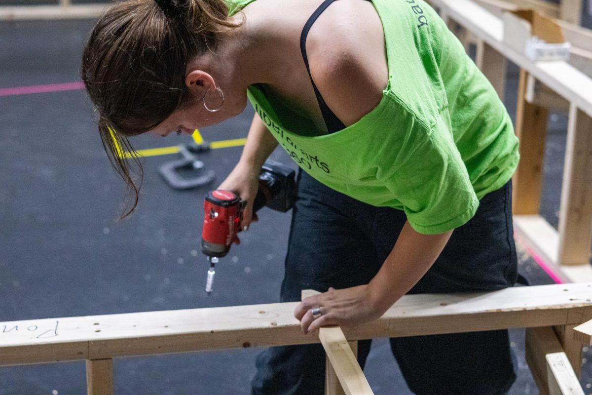 A student works on the set of "METAMORPHOSES." 