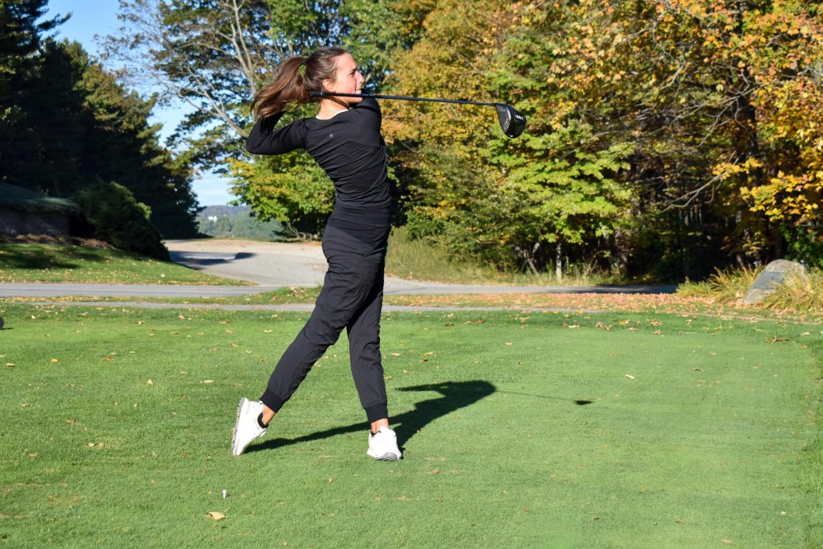 Sarah Wicks '28 following through her golf swing at Martindale Country Club in Auburn, Maine.