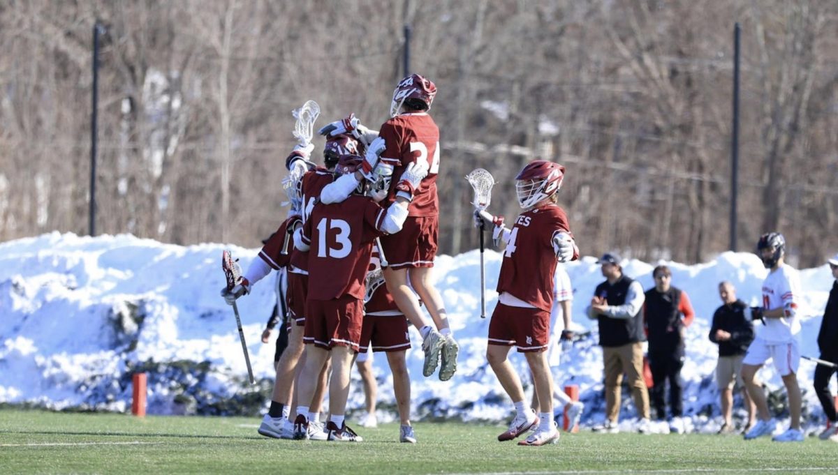 Bates Men's Lacrosse celebrating after a goal against No. 13 ranked Wesleyan University. Courtesy of Aaron Morse.